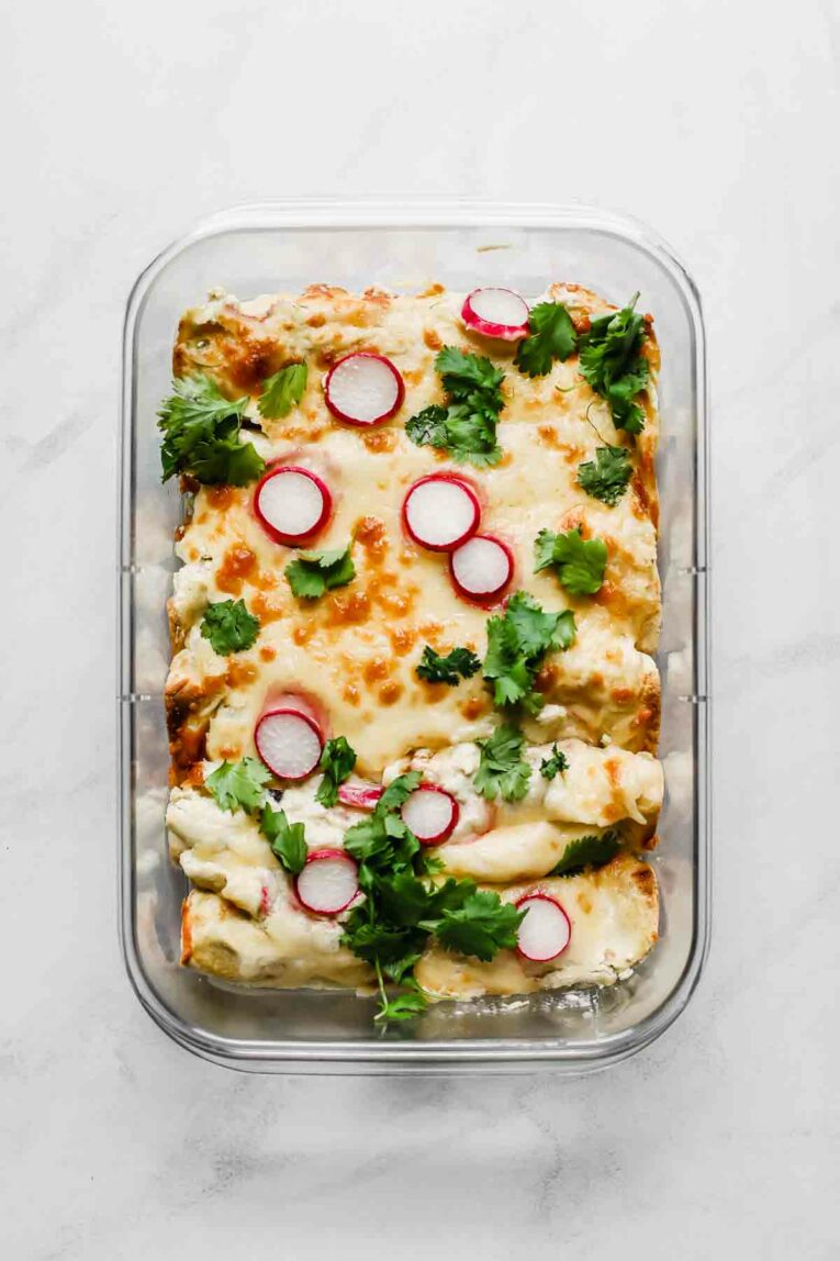 Skinny Creamy Chicken Enchiladas freezer meal recipe in a meal prep container.