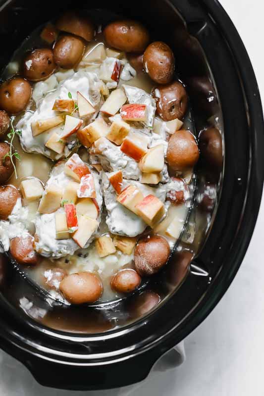 Slow Cooker Pork Chops And Potatoes W/ Apples in a slow cooker.