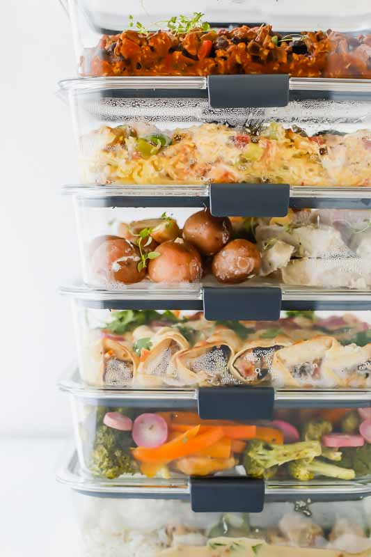 6 Healthy Freezer Meals For New Moms in meal prep containers stacked on top of each other.