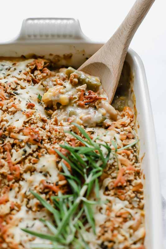 Overhead shot of baked vegetables with wooden spoon.