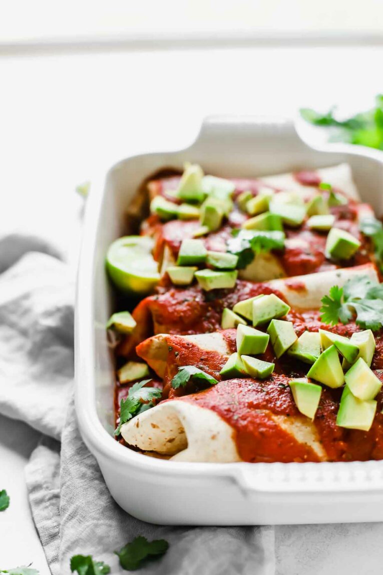 Side View of 5-Ingredient Vegan Enchiladas in a white baking dish.