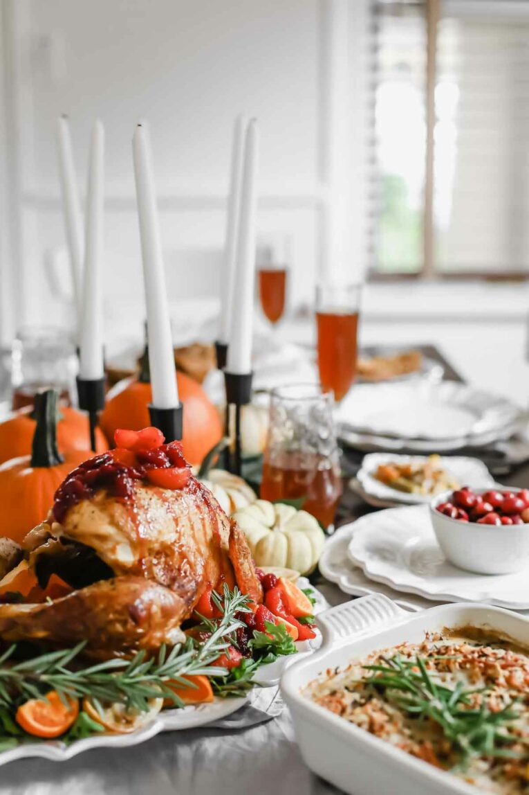 The BEST Citrus Tea-Glazed Roasted Turkey on a table set for Thanksgiving.