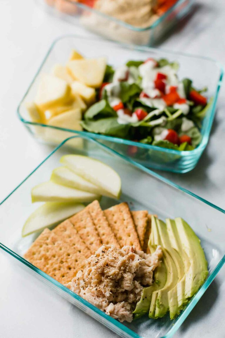 2 healthy lunches in meal prep containers on a countertop.