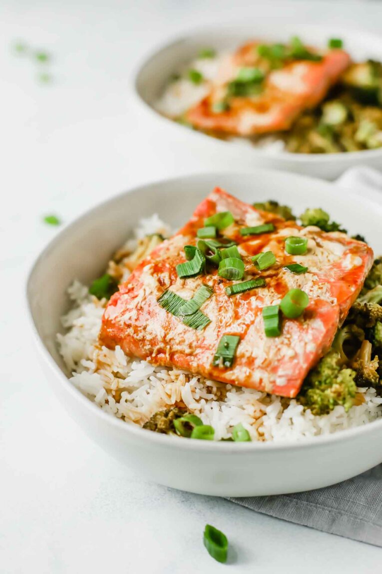 Baked salmon with teriyaki sauce over a bed of rice and broccoli.