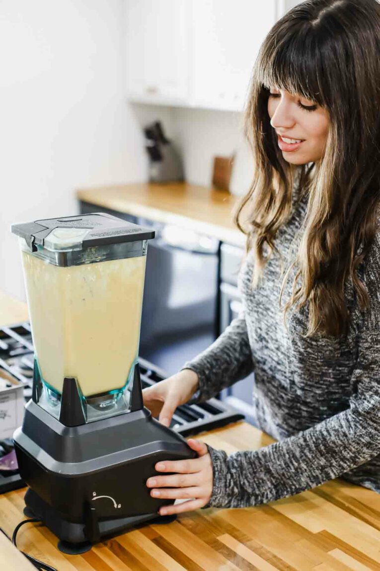 Easy Breakfasts w/ Smoothie Box (Honest Review) Woman blending a smoothie in the kitchen.