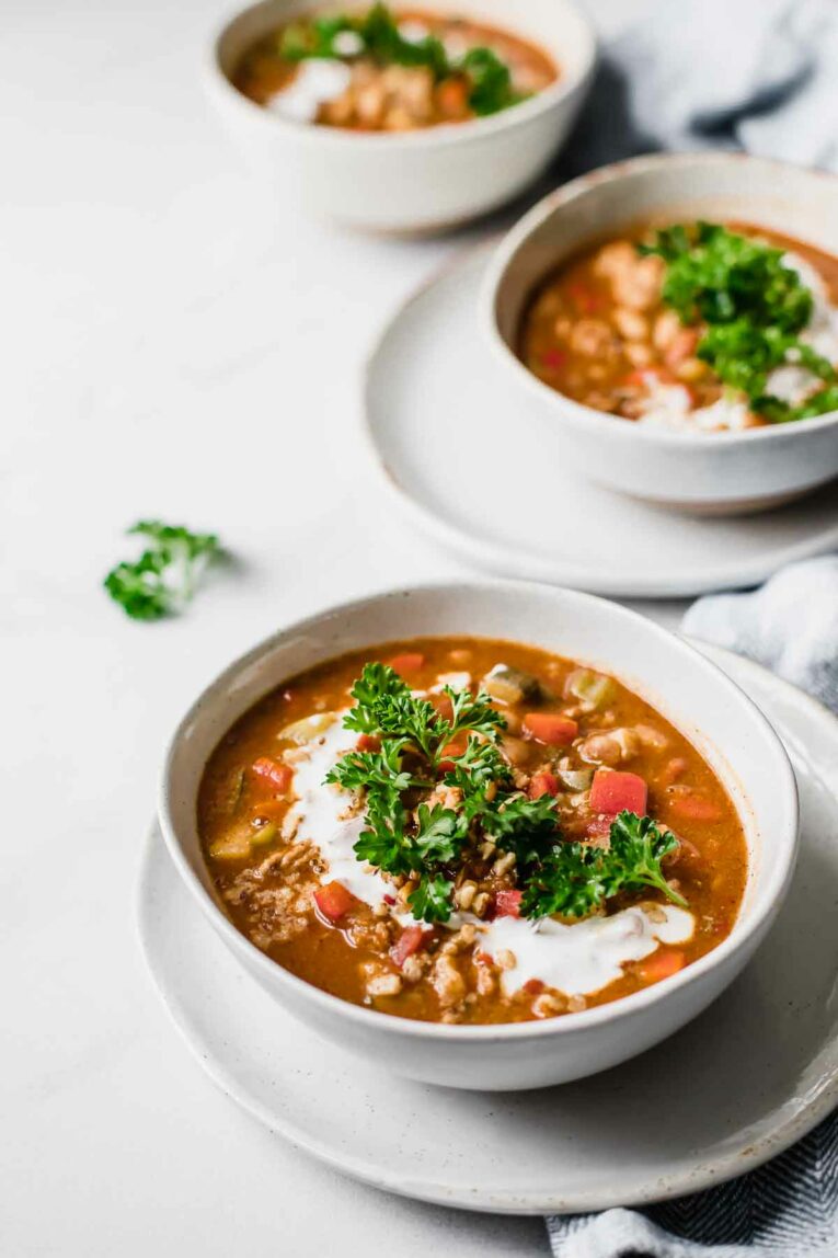 3 bowls of Veggie-Loaded Slow Cooker Turkey Chili on a marble table