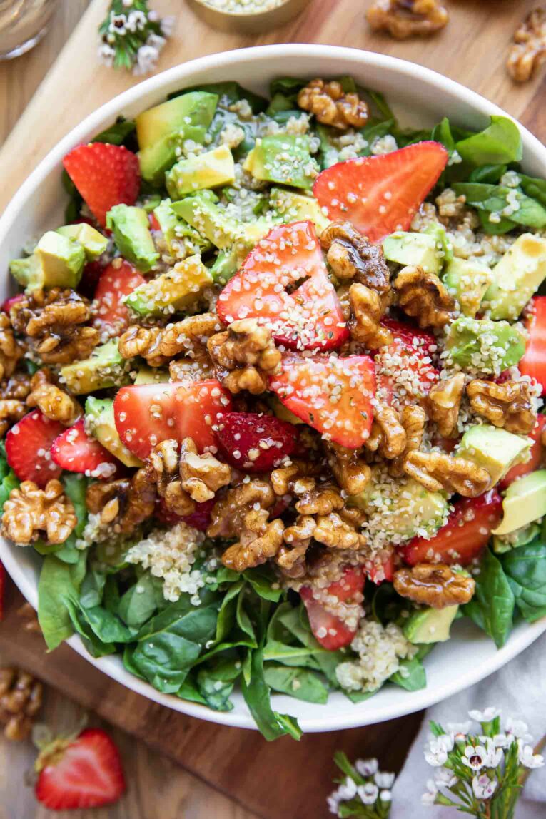 Healthy Spring Salad Recipe - Springtime Avocado Strawberry Spinach salad in a white bowl.
