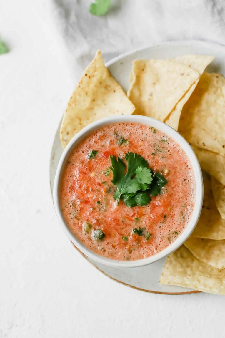 The BEST Easy Salsa Recipe made with plum tomatoes, jalapeño, and cilantro. So yummy! The best easy salsa recipe in a white bowl topped with fresh cilantro