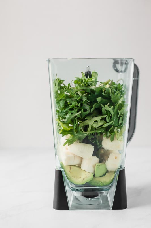 Kale, banana, and avocado in a blender.