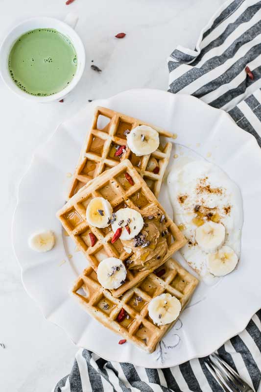 Easy protein waffles recipe served with fruit, yogurt, and Vital Proteins Matcha Collagen.