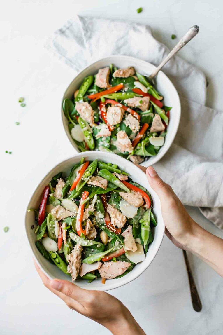 Looking for a quick and easy solution to healthy weeknight dinners? Then Sun Basket might be for you. Today, I'm sharing all about my week with Sun Basket (an honest review along with an unboxing video and a promo code)! Sun Basket salmon and veggies dinner in bowls.