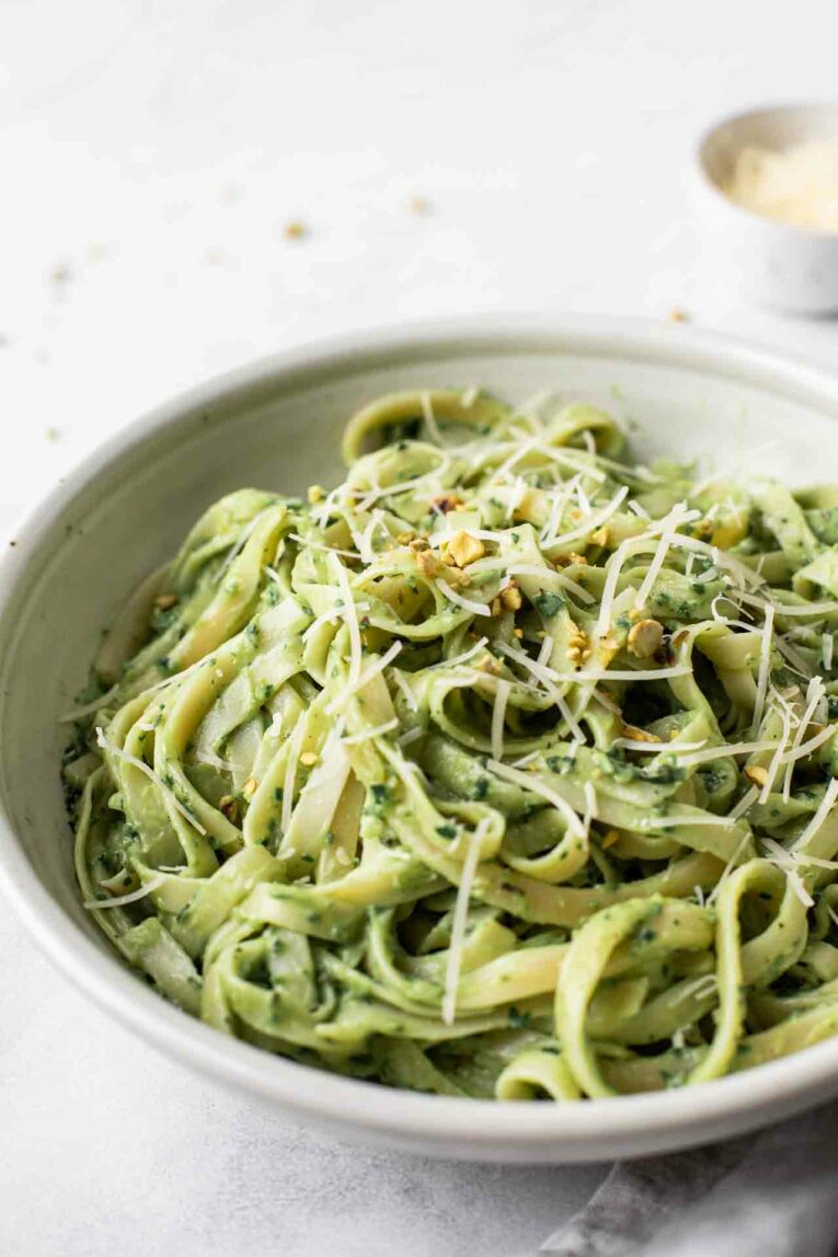 The BEST Avocado Pasta Sauce that can be made in 10-minutes or less! It's quick, easy, healthy, gluten-free, dairy-free, vegan, and delicious. Perfect for dinner tonight! Close up of fettuccine with avocado pasta sauce.