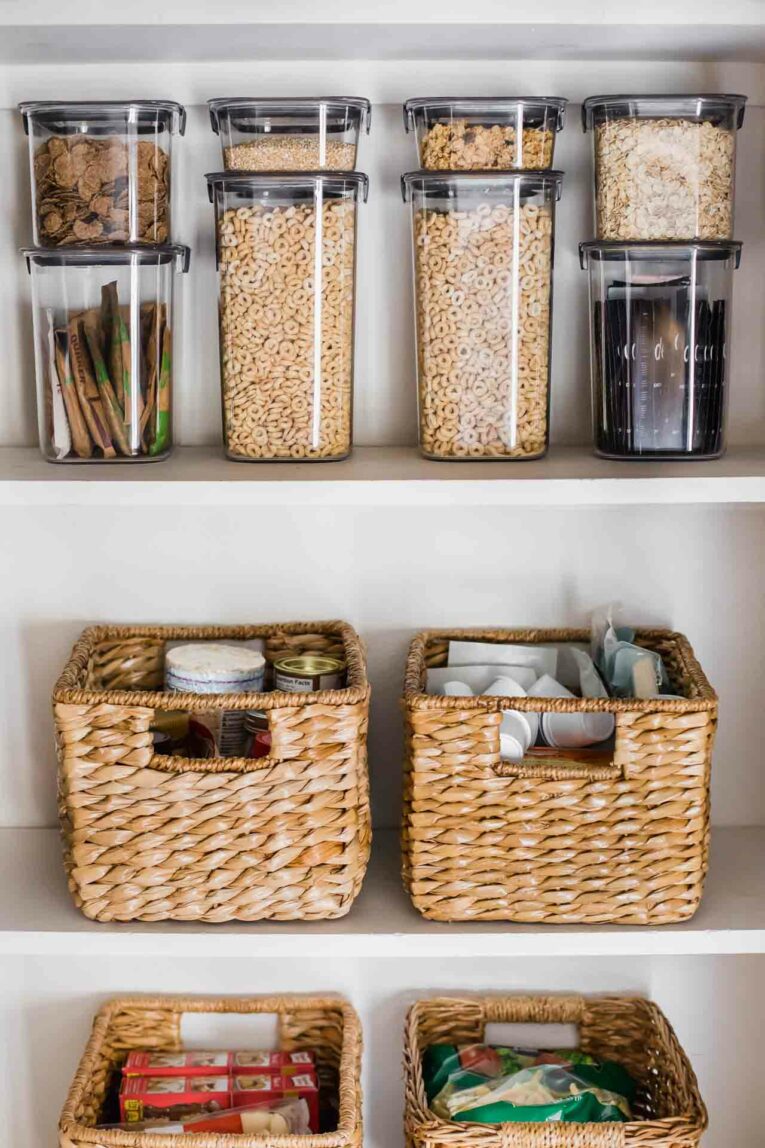 Organized pantry with airtight containers and baskets.