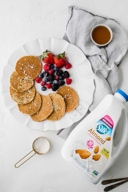 Almond Milk pancakes with berries on a plate.