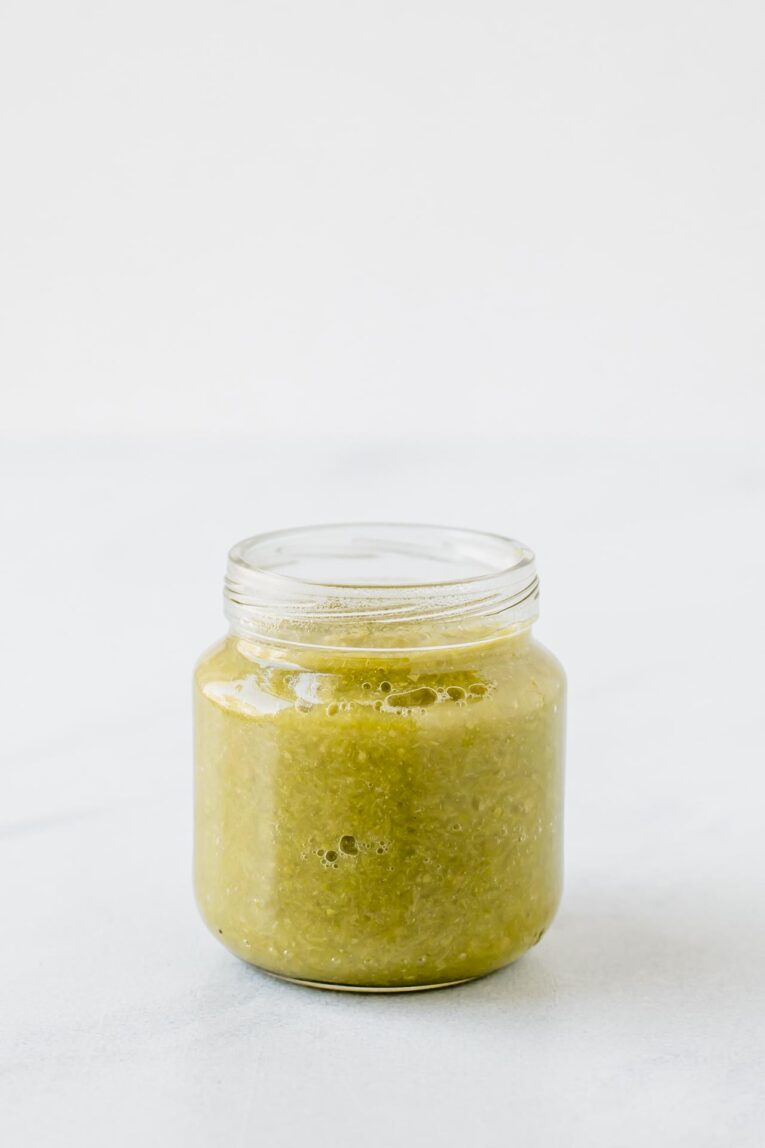 Asparagus and rice baby food puree in a baby food jar.