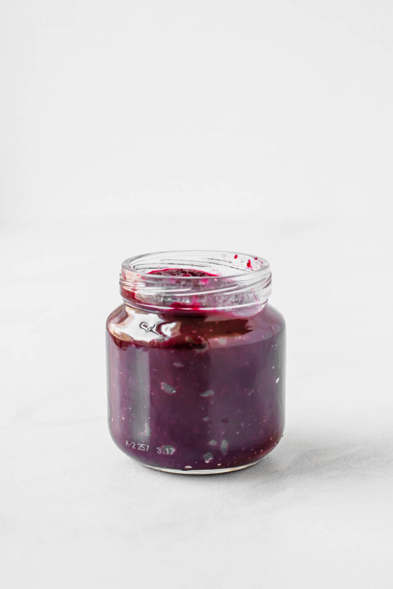 Beets & blueberries baby food recipe in a baby food container.