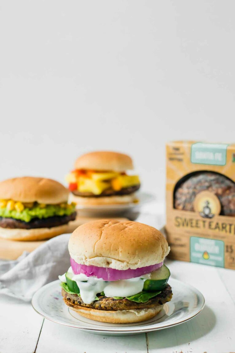 3 veggie burgers served on plates.