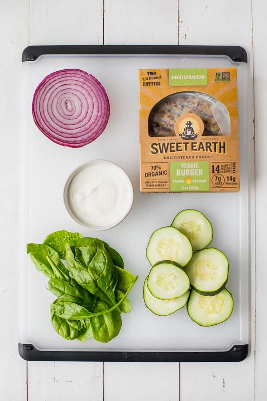 Veggie burger ingredients on a cutting board.