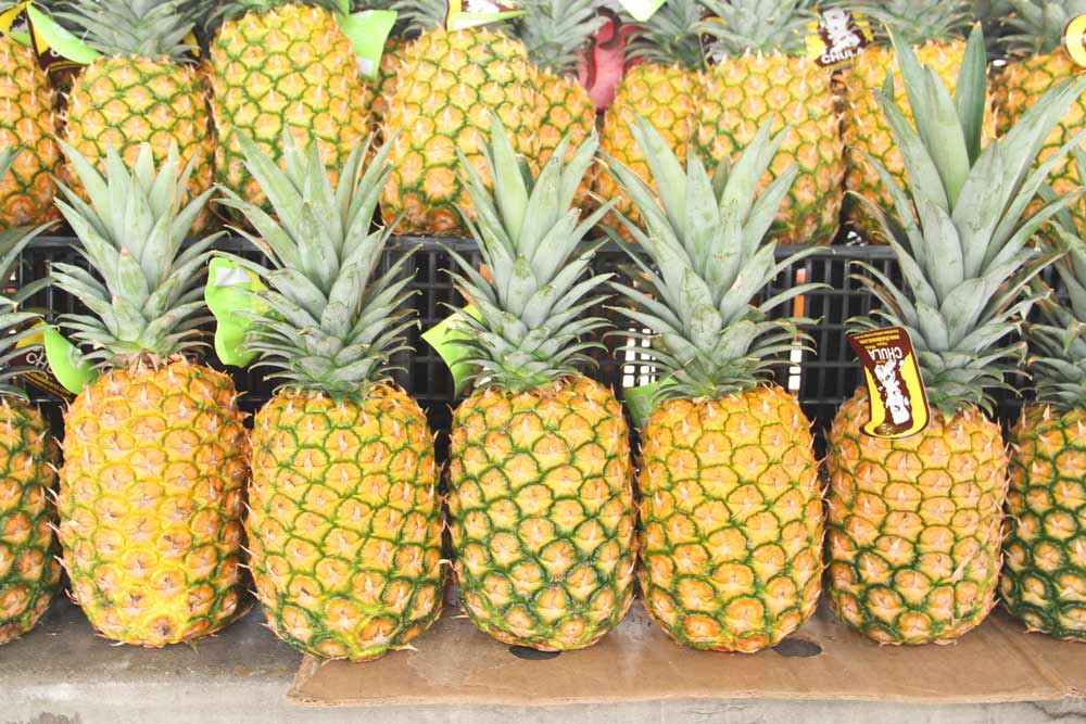 15 Summer Fruits For Everyday Recipes fresh pineapples at a market