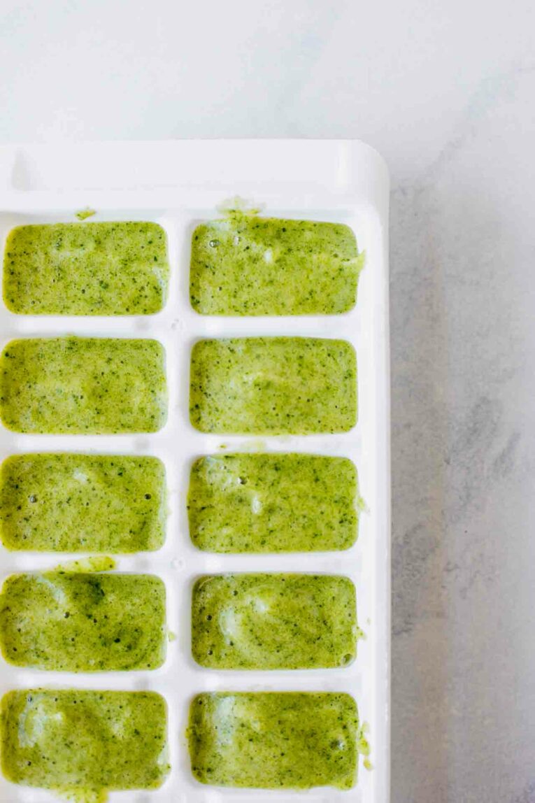 Pineapple & Spinach Baby Food recipe in an ice cube tray. The perfect puree for your baby!