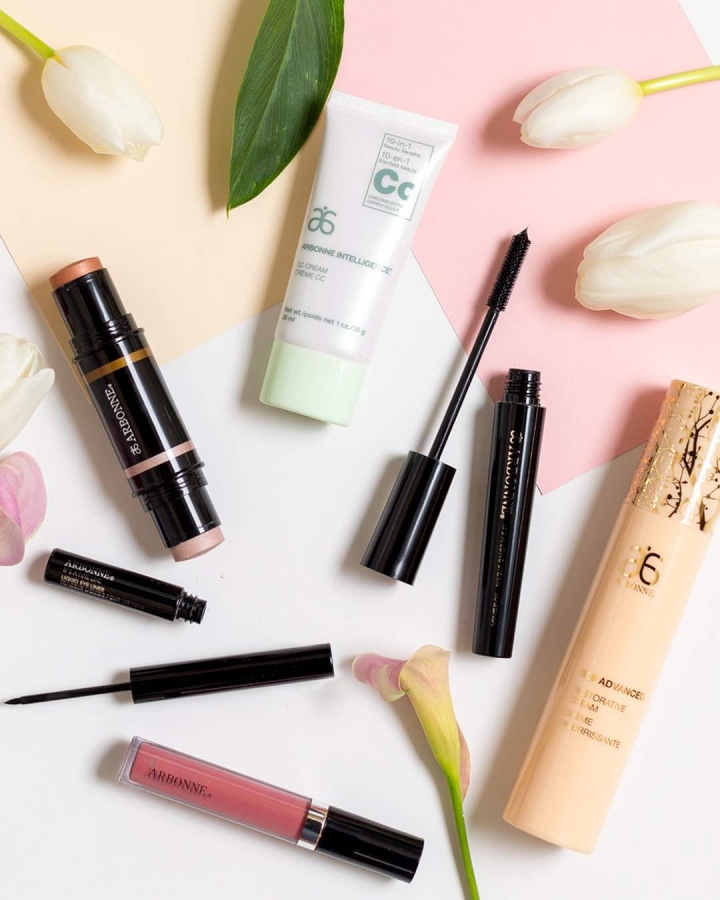 Want to know what the best Arbonne products are and what's so great about them? Today I'm sharing an honest review and amazing discount. If you're looking to make the switch to healthier, pure, botanical-based products and nutrition, then this post is for you! Arbonne Makeup scattered on a pastel surface with tulips