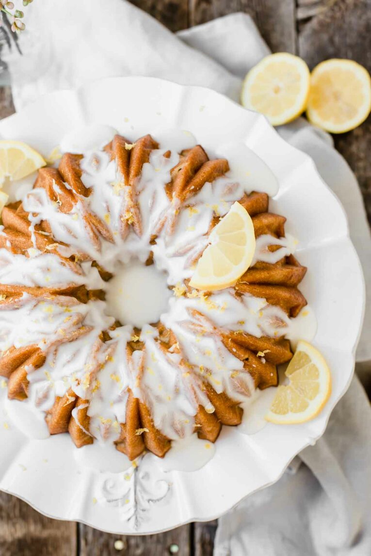 Looking for an easy dessert that will impress your guests at your next summer gathering? This Southern Sweet Tea Lemon Cake is light, fluffy, sweet, and tastes like everything summer! Top shot of southern sweet tea lemon bundt cake.