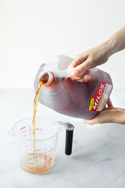 Milo's sweet tea pouring into a measuring cup.