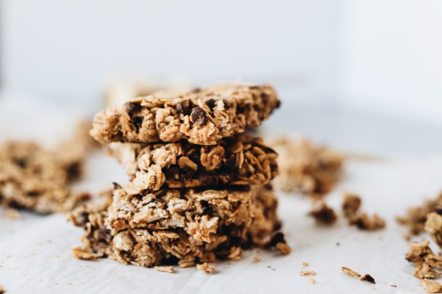 The BEST Baked Breakfast Oatmeal Bars stacked on a white surface.