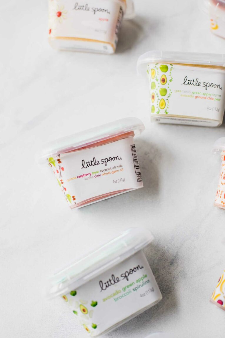 Little Spoon Organic Baby Purees on a white surface.