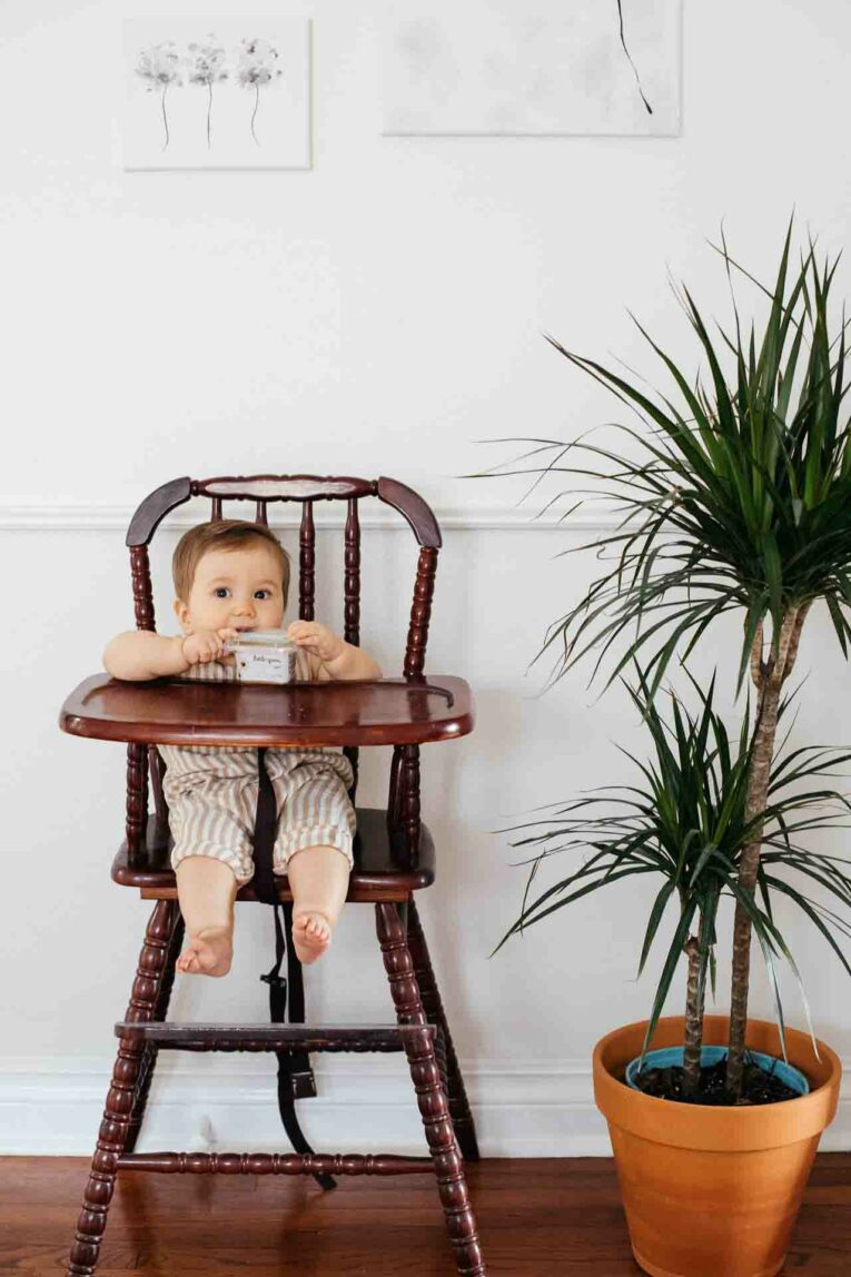 Baby in a high chair, eating Little Spoon Organic Baby Food