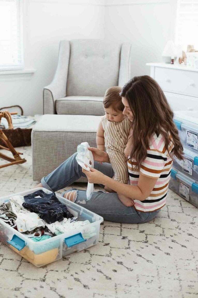 Mom and baby storing baby clothes.