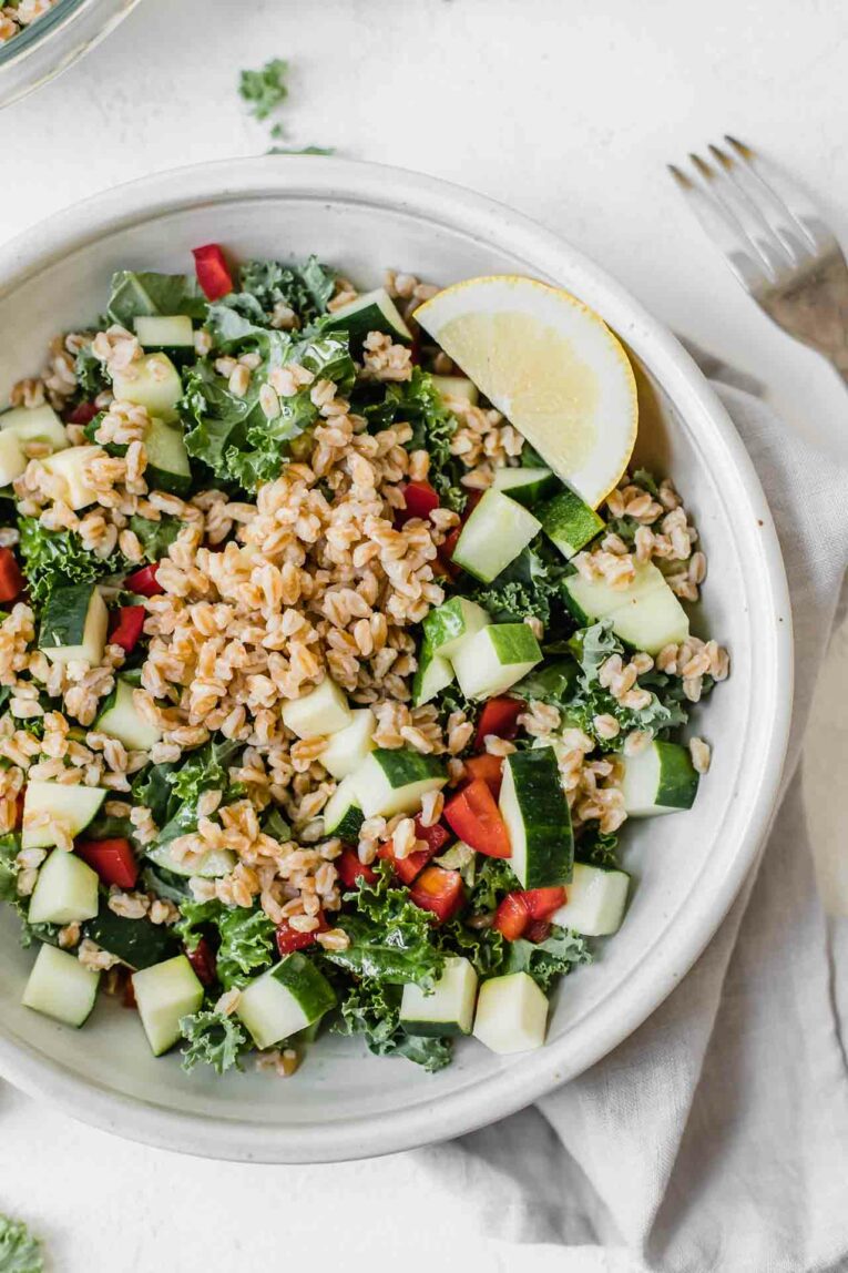 Close up of 10-Minute Mediterranean Farro Salad made with kale, cucumbers, zucchini, red pepper, farro, and lemon vinaigrette. 