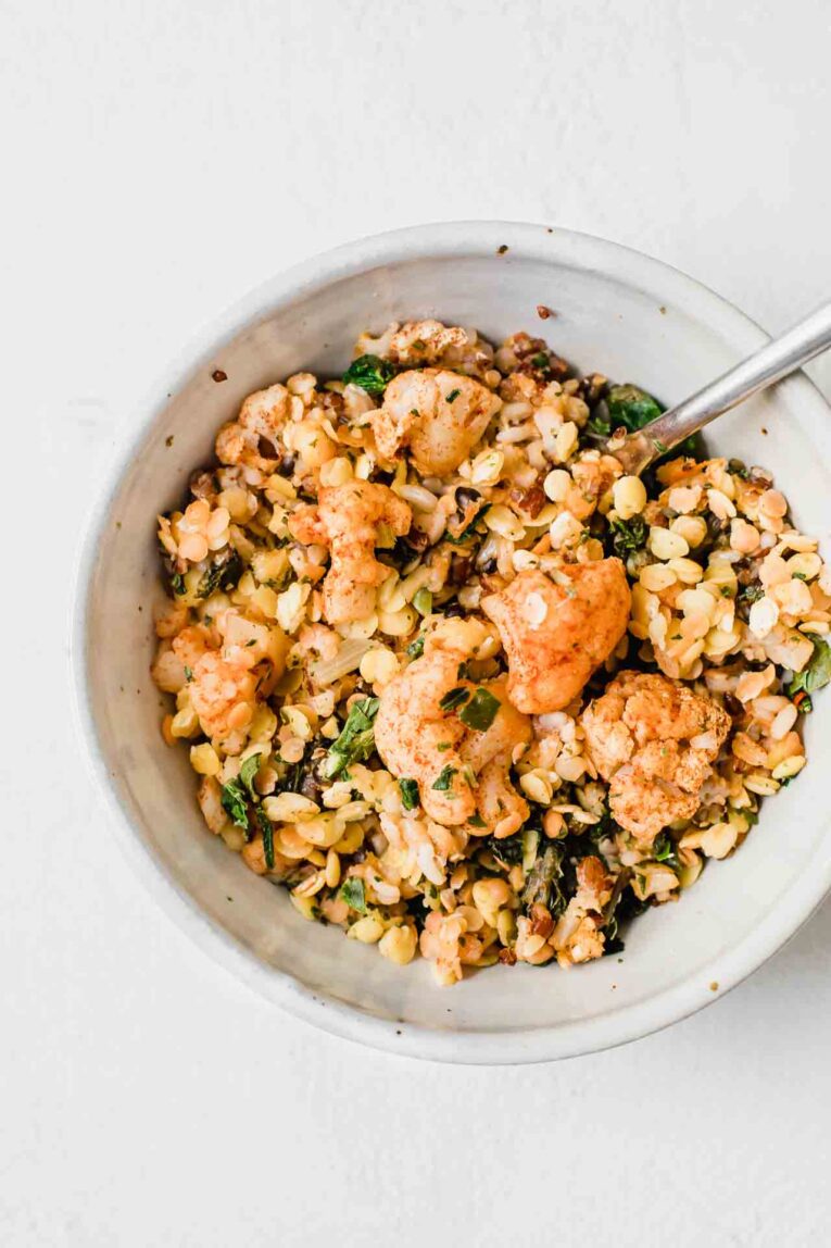 Cauliflower and lentils in a white bowl.