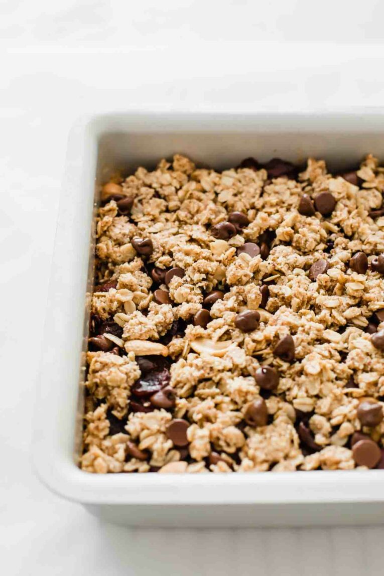 Chocolate Cherry Crumble Dessert Bars baking in a square cake pan.