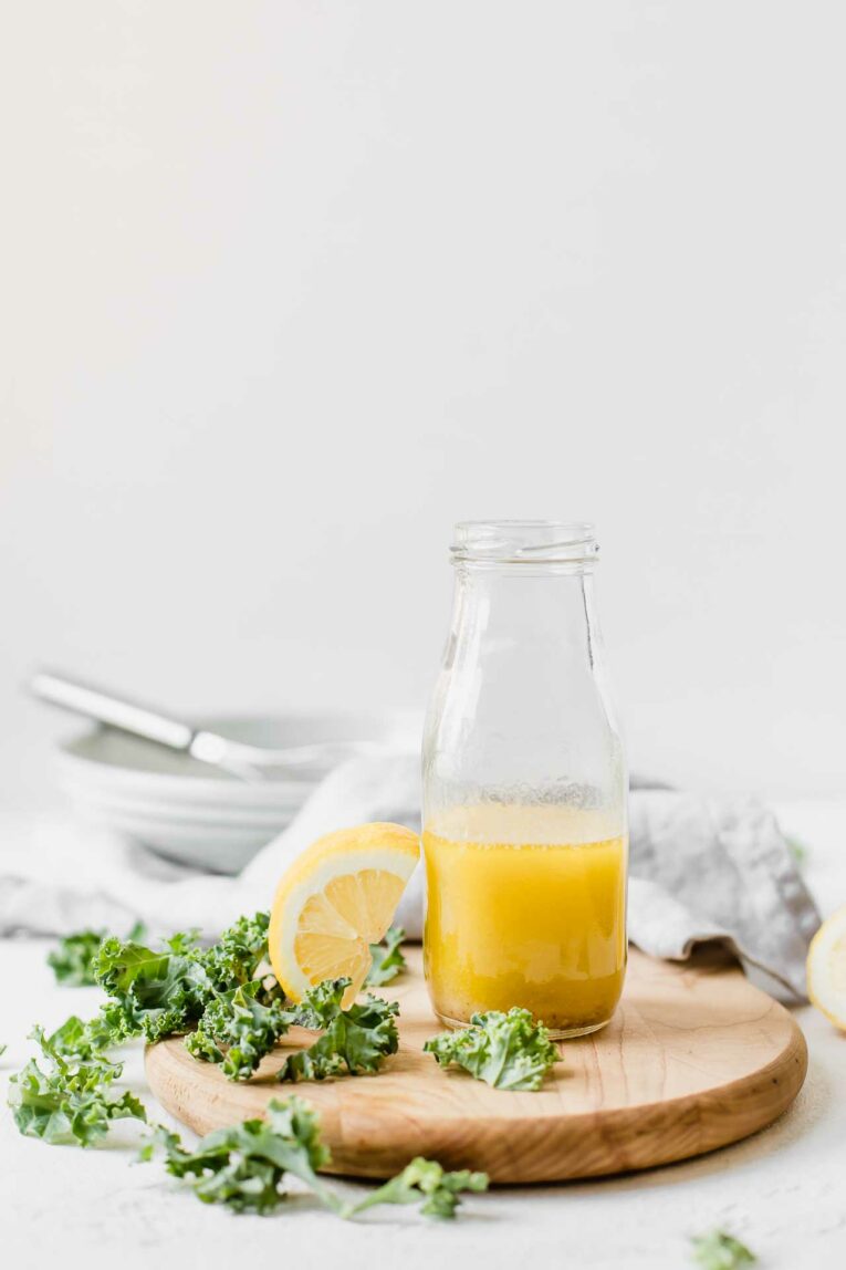 Easy to make classic lemon vinaigrette on a wood cutting board.