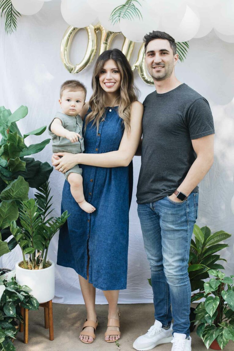 Tropical Plant First Birthday Party Family baby boy first birthday party. Parents with baby boy.