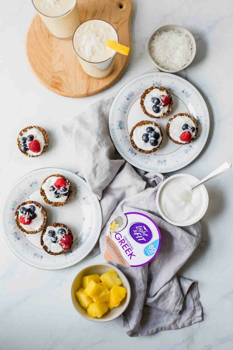 Image of smoothies and yogurt cups served on cutting boards and plates with yogurt.
