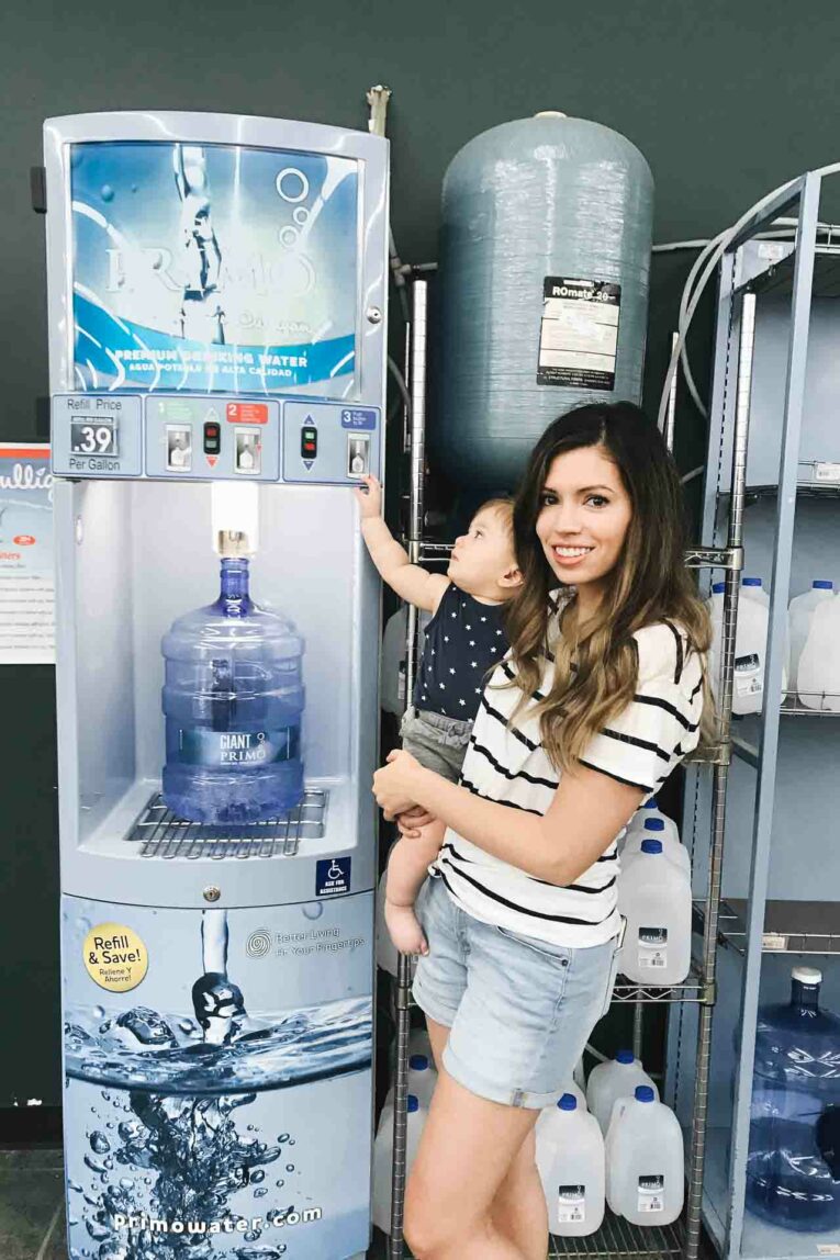 Curious to know what the best drinking water is for your baby, toddler, and entire family? Today we're sharing all about how to find the best drinking water, how to prepare formula with it, and how to implement an easy plan to keep high quality water on hand! Mom holding baby next to primo water