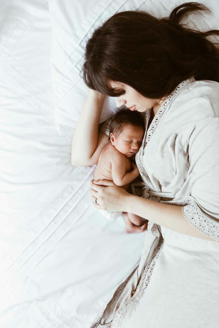 The months following the birth of your little one can be such a fun and exciting time! However, they can also be challenging, busy, exhausting, and tricky to navigate. Today, we're sharing our favorite tips for surviving the fourth trimester! Mom laying in bed with newborn baby