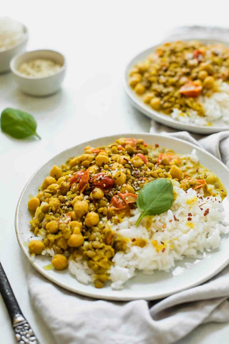 Angle Shot of Chickpea Curry Served with Rice on a plate.