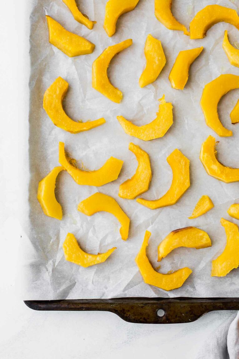 Roasted Pumpkin slices on a baking sheet.