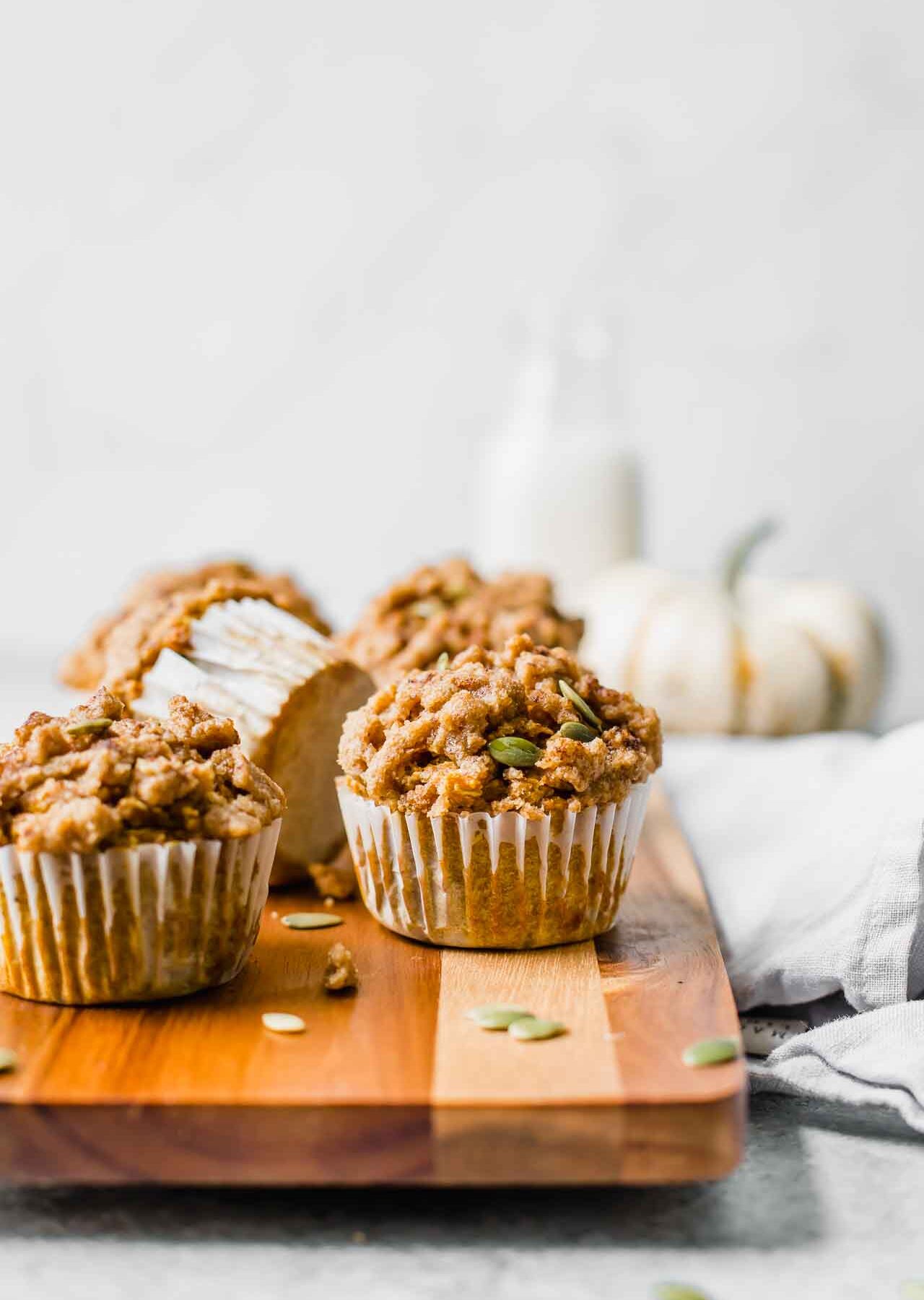 Healthy pumpkin muffins as a fall brunch idea on a cutting board.