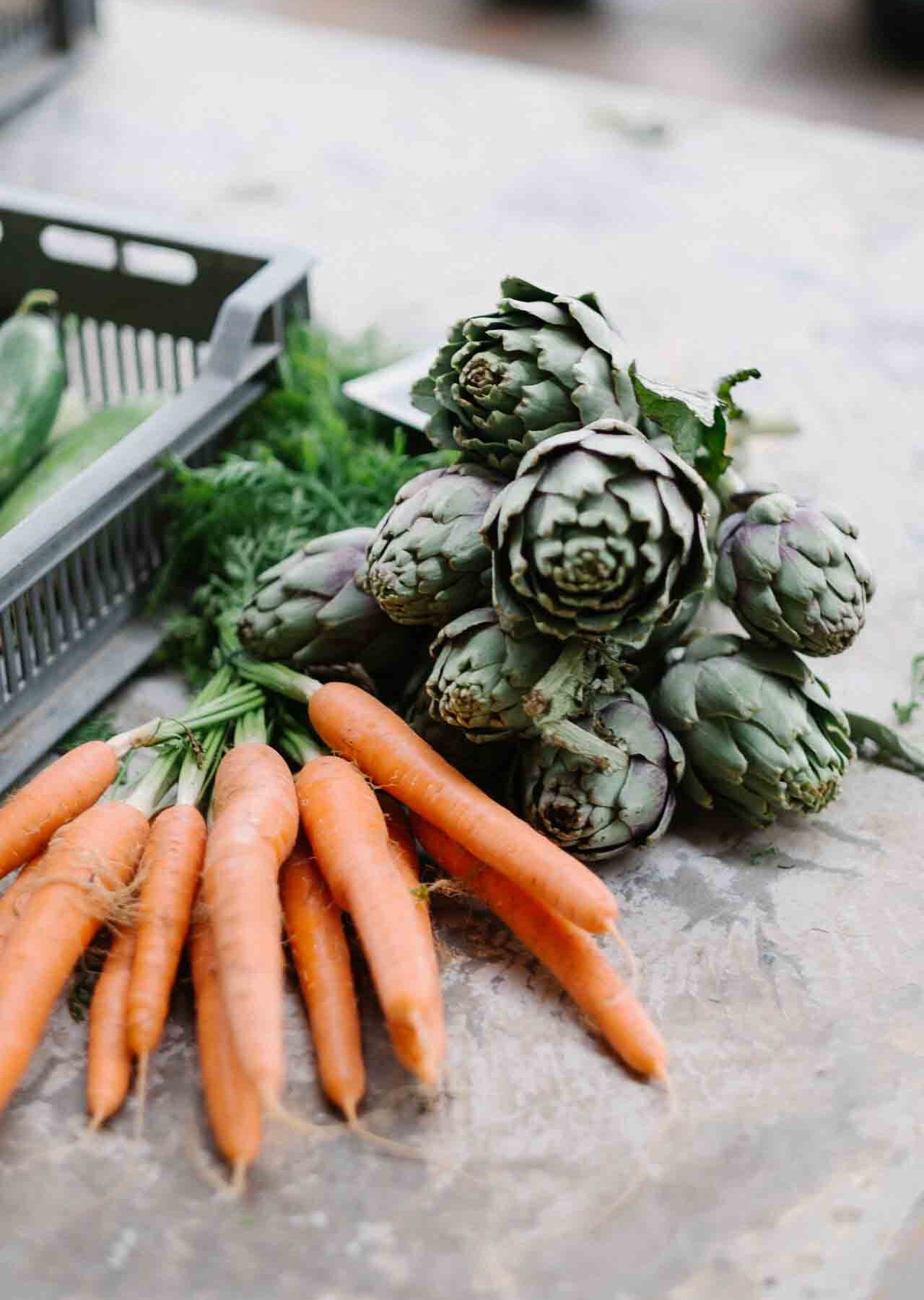 Carrots and Brussel sprouts on a counter.