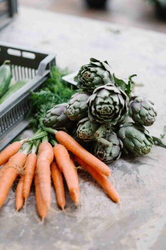 Carrots and Brussel sprouts on a counter.