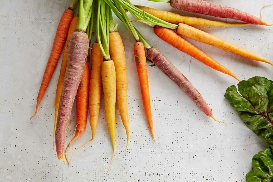 Raw Carrots and Lettuce on a White Background
