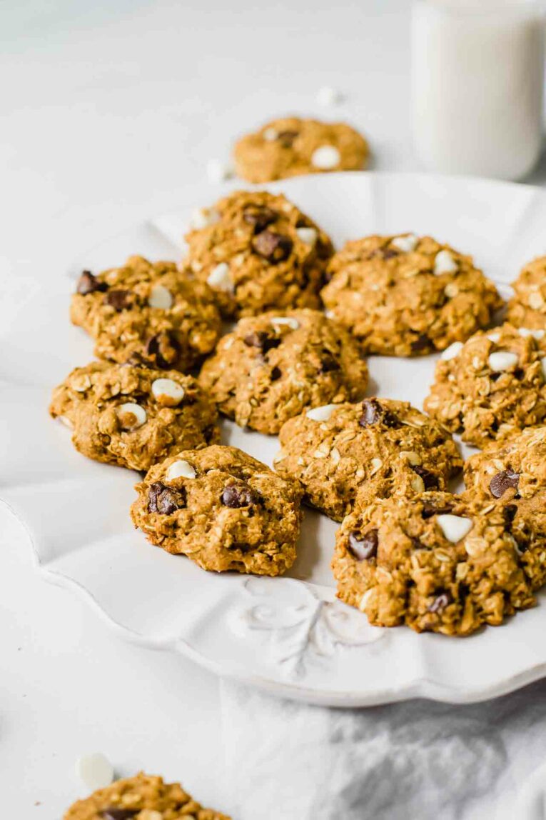 Side shot of healthy pumpkin oatmeal cookies on a white plate.