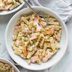 Top shot of Creamy Salmon Pasta in a white bowl with a fork.