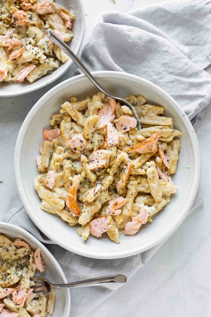 Top shot of Creamy Salmon Pasta in a white bowl with a fork.