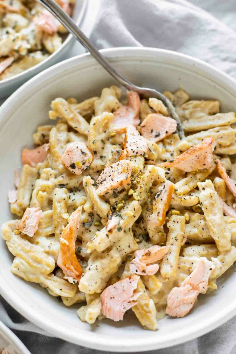 Close up of Creamy Salmon Pasta in a white bowl.