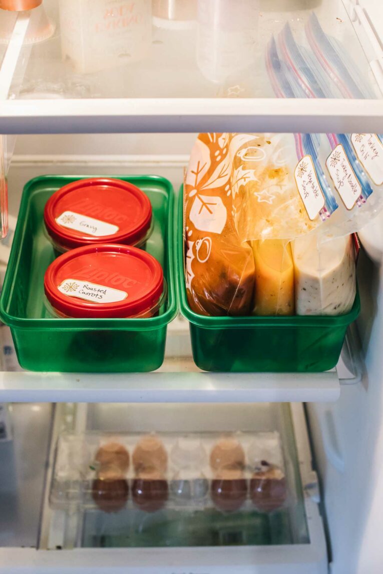 Thanksgiving leftovers organized in green Ziploc containers with freezer bags.